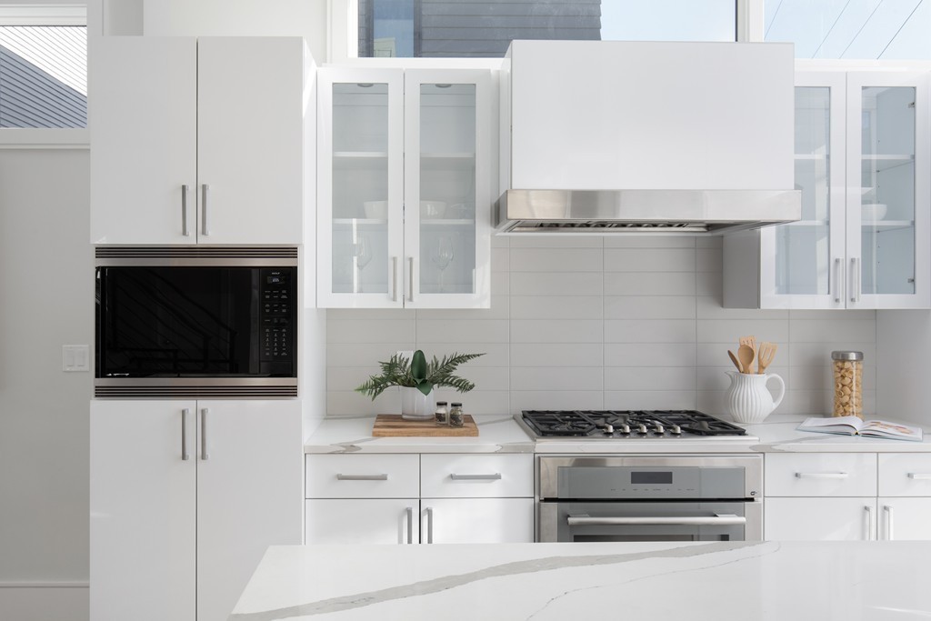 9 Decatur Street, Unit 1 Cambridge, MA 02139 - Photo 3 of 12 a kitchen with stainless steel appliances a stove a microwave and cabinets