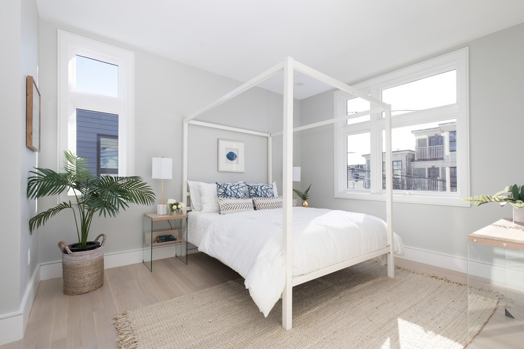 9 Decatur Street, Unit 1 Cambridge, MA 02139 - Photo 4 of 12 a bedroom with a large bed and a potted plant