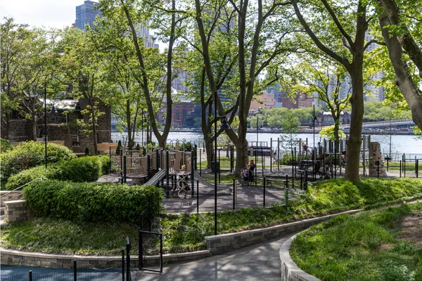 a view of a yard with a fountain and a bench
