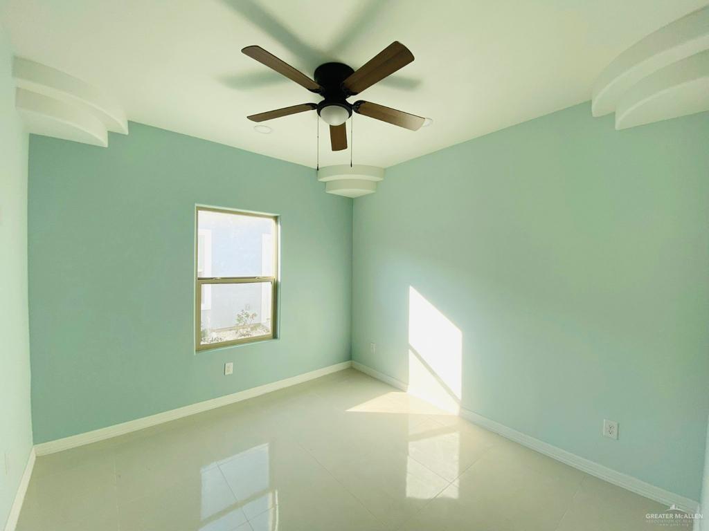 209 West Rutherford Avenue, Unit 4 Edinburg, TX 78541 - Photo 12 of 14 a view of empty room with wooden floor and fan