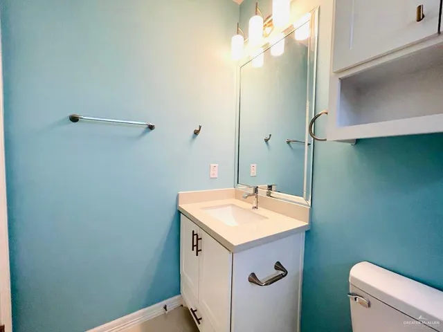 a bathroom with a sink a toilet and a mirror