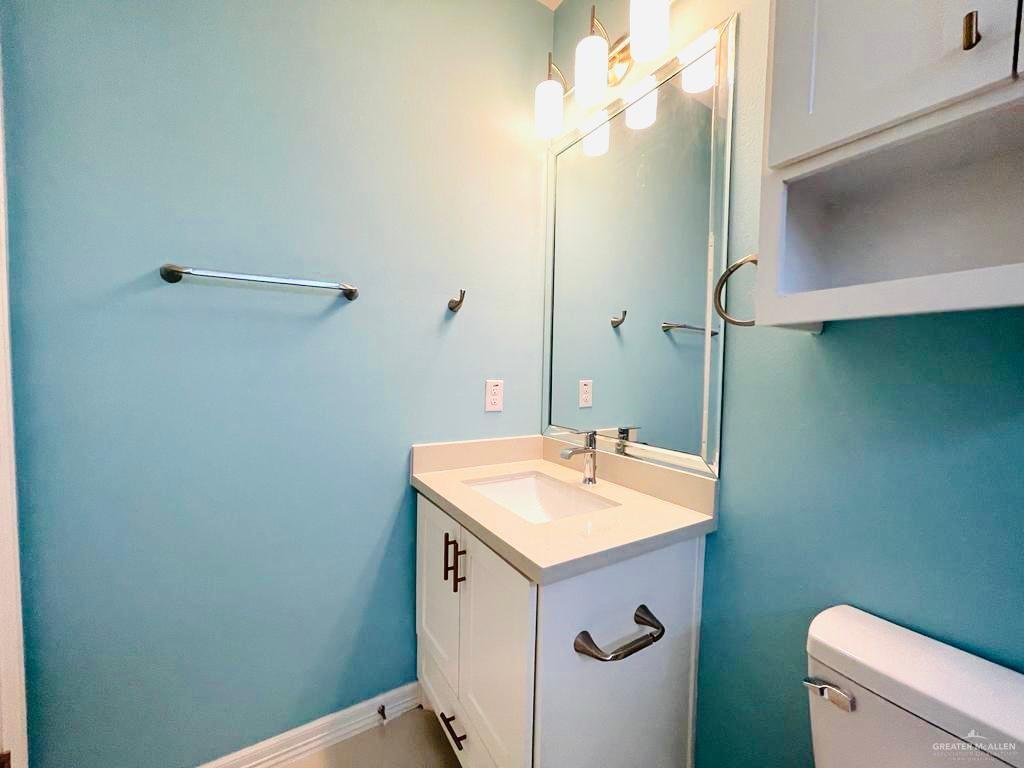 209 West Rutherford Avenue, Unit 4 Edinburg, TX 78541 - Photo 14 of 14 a bathroom with a sink a toilet and a mirror