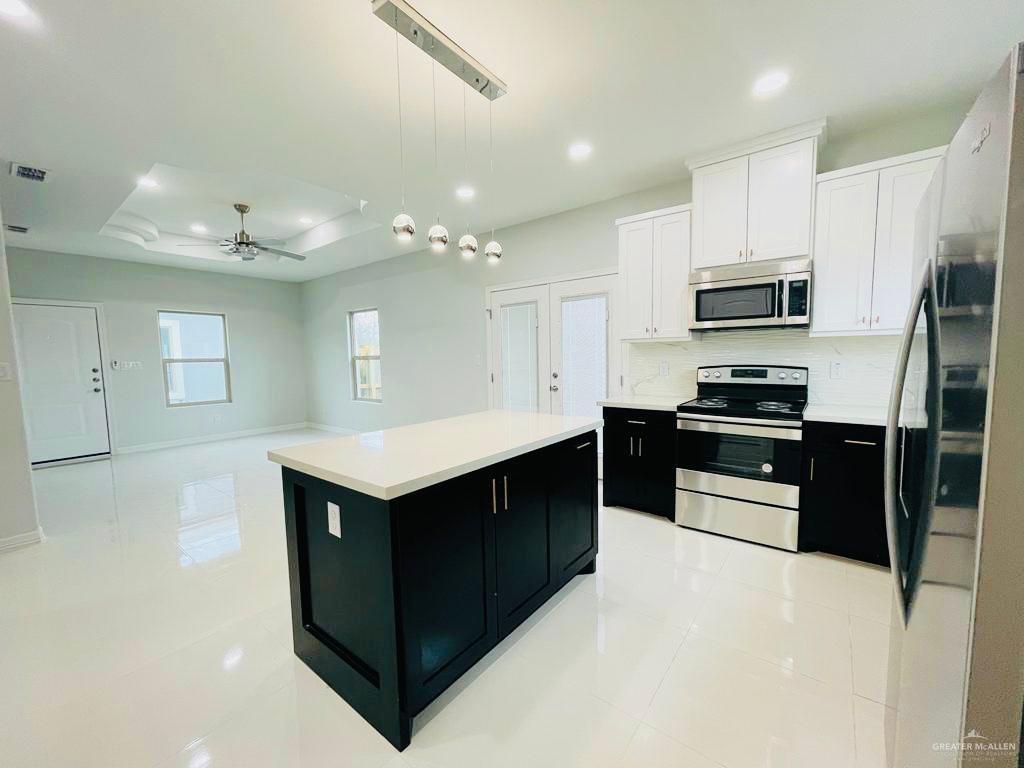 209 West Rutherford Avenue, Unit 4 Edinburg, TX 78541 - Photo 3 of 14 a kitchen with granite countertop a refrigerator and a stove top oven