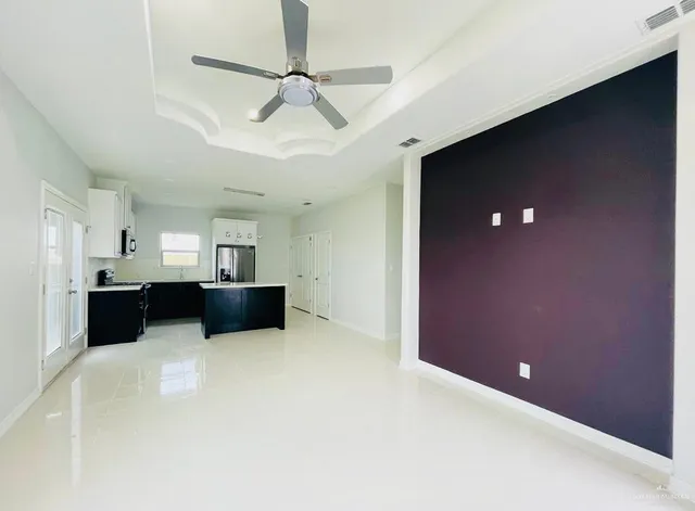 a view of a livingroom with a furniture and a ceiling fan
