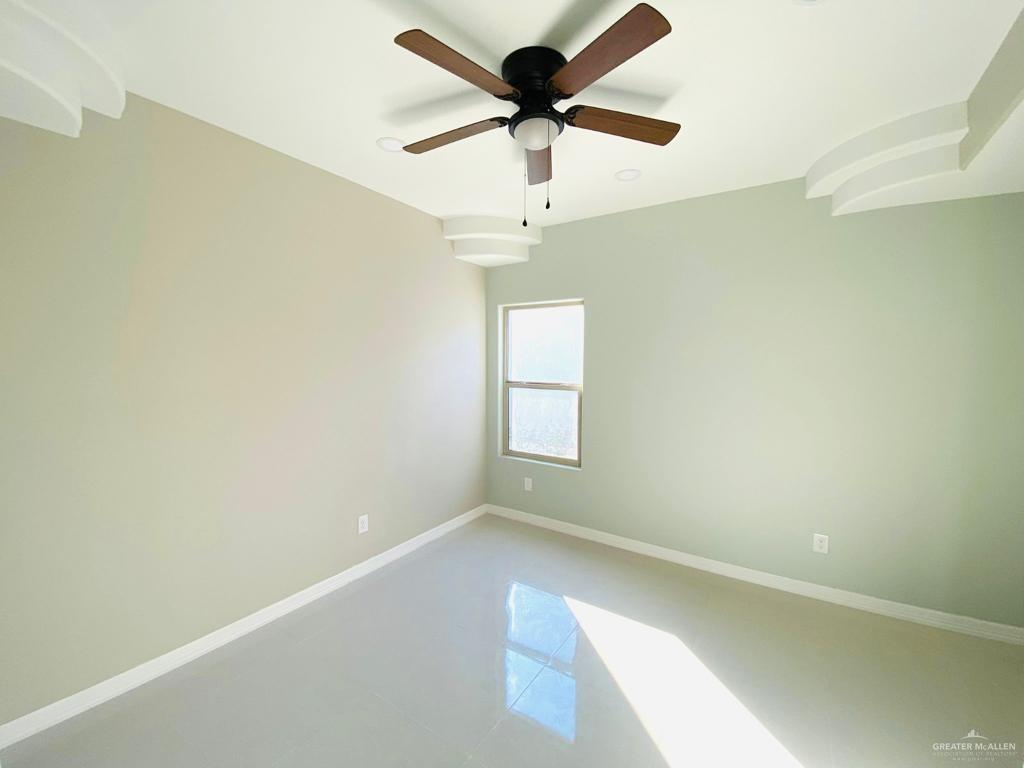 209 West Rutherford Avenue, Unit 4 Edinburg, TX 78541 - Photo 10 of 14 an empty room with a window and a fan
