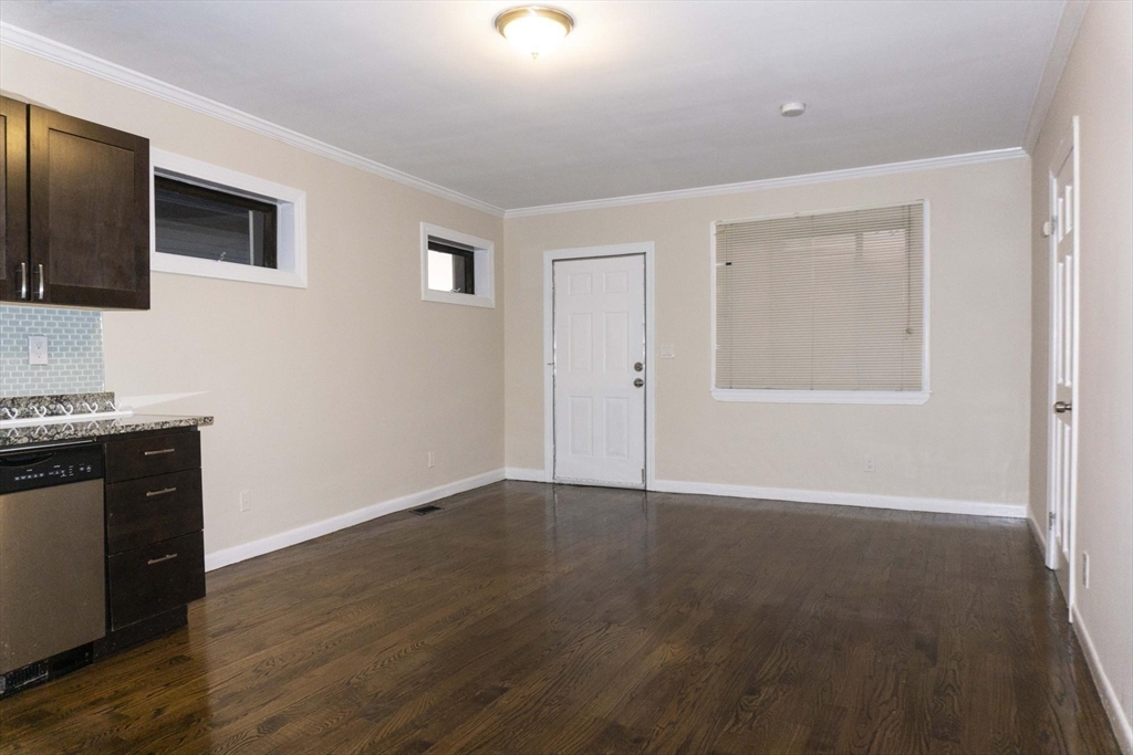 75 Elm Street Watertown, MA 02472 - Photo 8 of 12 a view of an empty room with wooden floor and a window