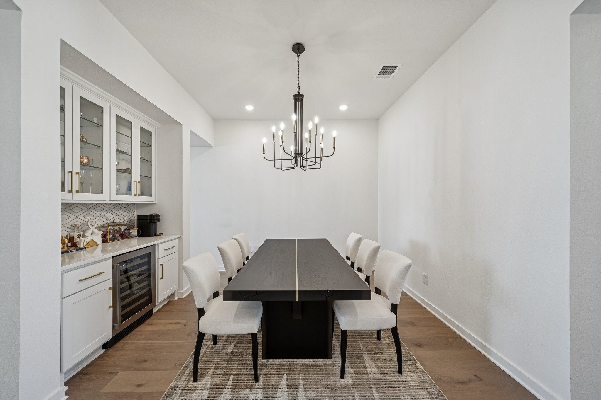 8703 Blue Grotto Lane Manvel, TX 77578 - Photo 13 of 43 The formal dining room can house any size table for large gatherings, and the built-in hutch with wine fridge allows for efficient serving.