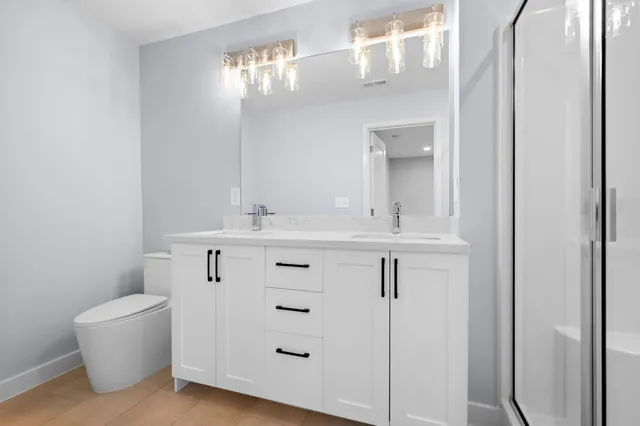 a bathroom with a double vanity sink mirror and double
