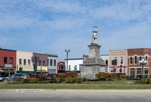 a view of a park with plants and palm trees