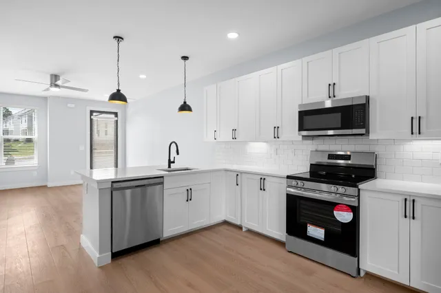 a kitchen with stainless steel appliances granite countertop a sink and stove top oven