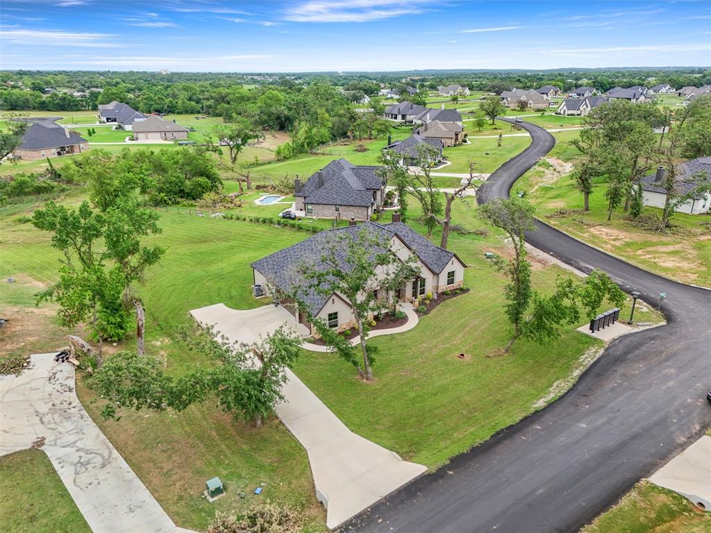 105 Clayton Crossing Springtown, TX 76082 - Photo 36 of 40 a view of a swimming pool with a yard