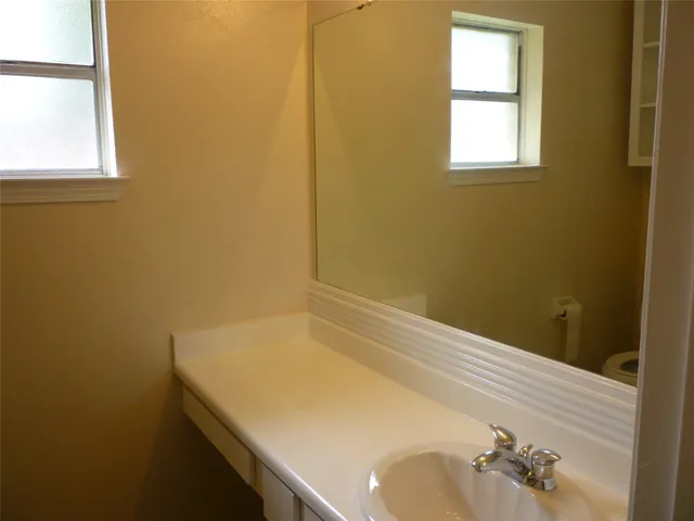 a white toilet sitting next to a shower