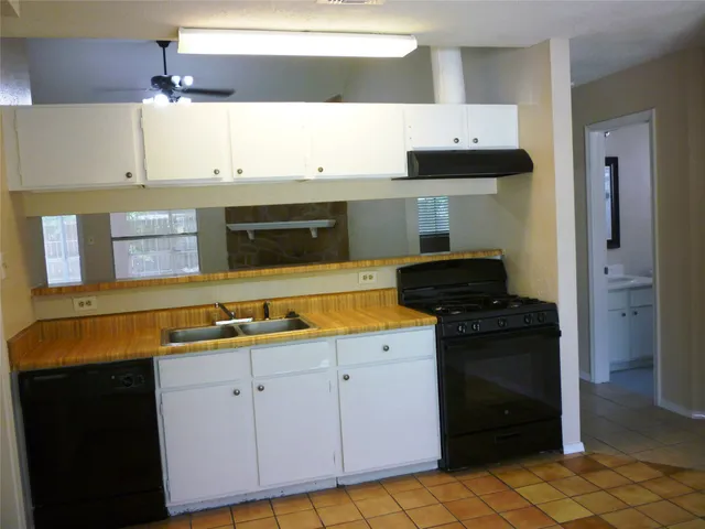 a kitchen with a stove and a cabinets