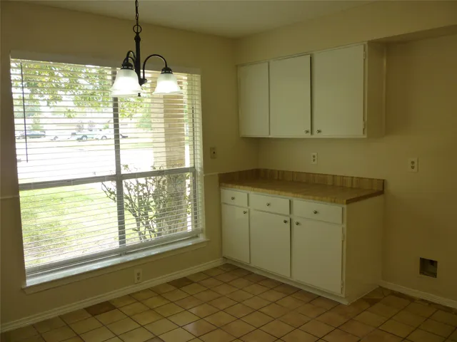 a room with a window and ceiling fan