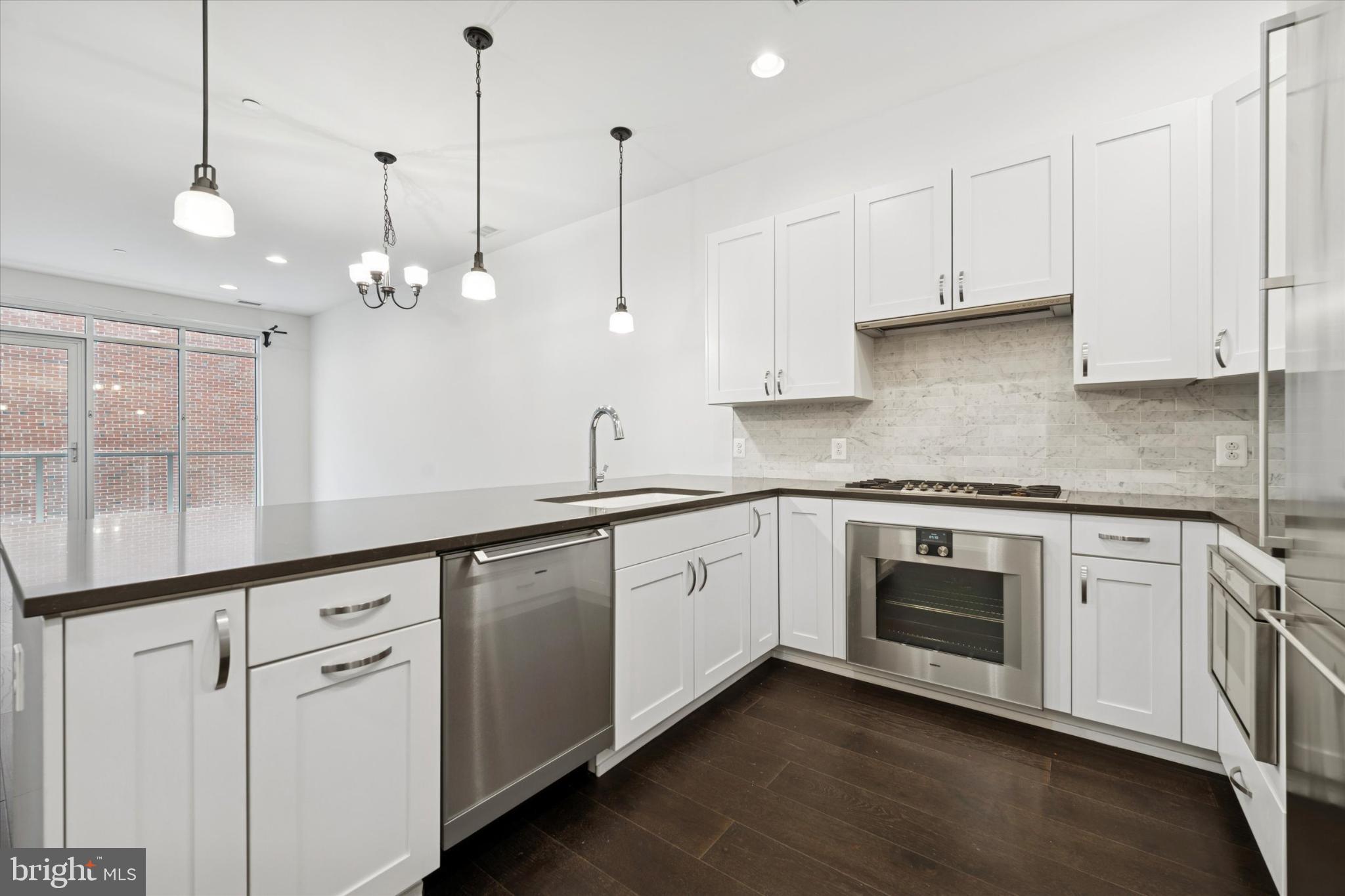 410 South Front Street, Unit 313 Philadelphia, PA 19147 - Photo 1 of 24 a kitchen with white cabinets white appliances and sink