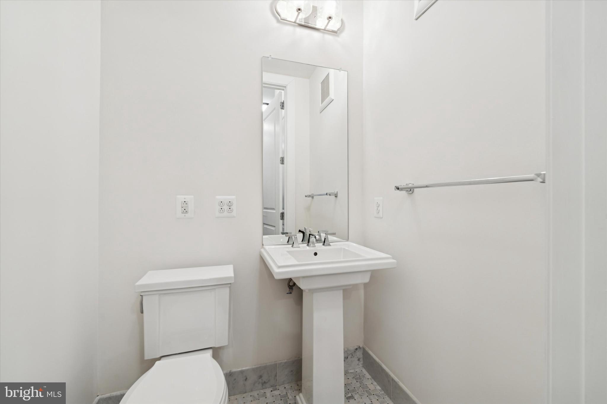 410 South Front Street, Unit 313 Philadelphia, PA 19147 - Photo 15 of 24 a bathroom with a sink toilet and a mirror