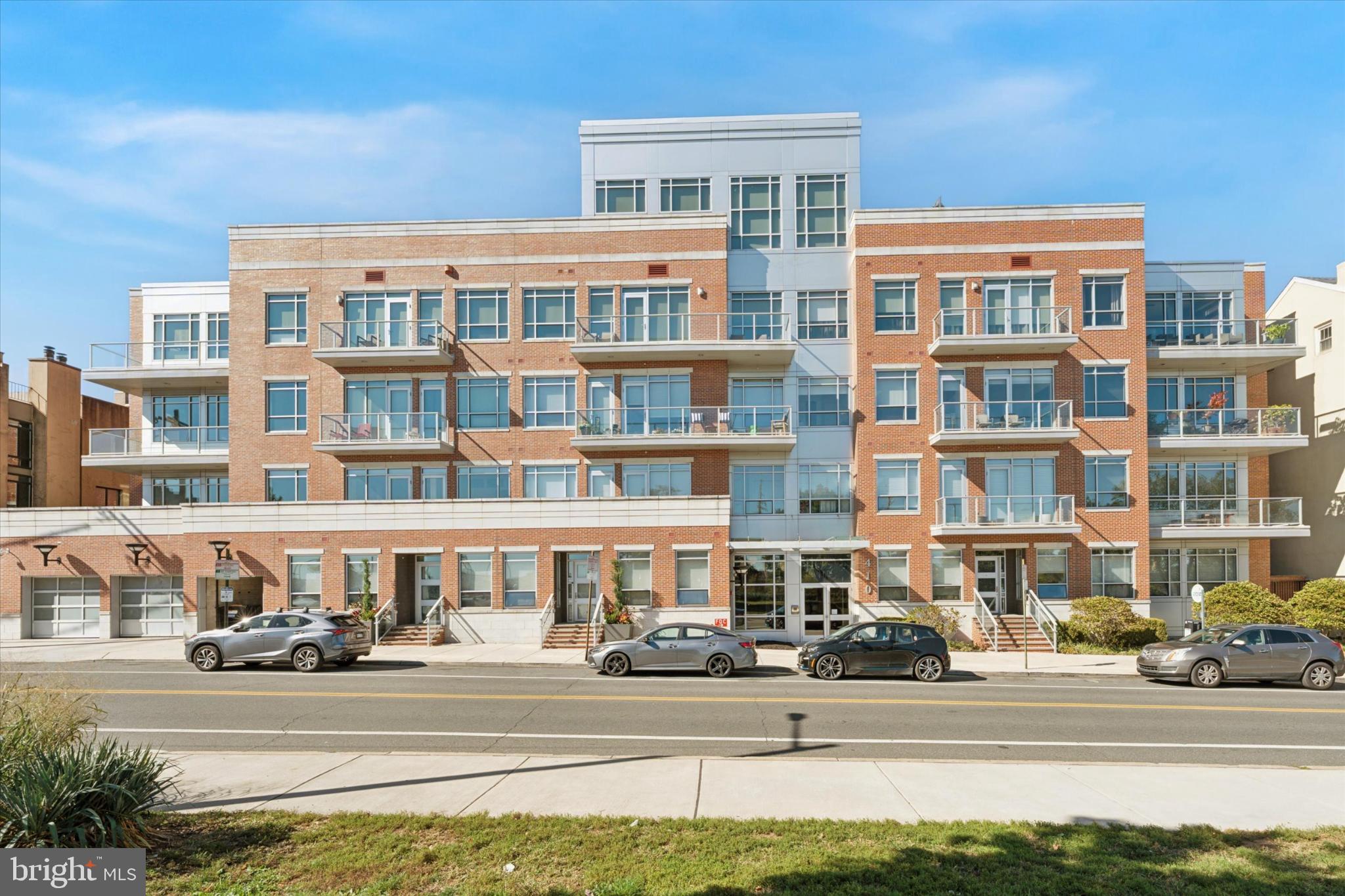 410 South Front Street, Unit 313 Philadelphia, PA 19147 - Photo 20 of 24 a front view of a building with a garden and plants