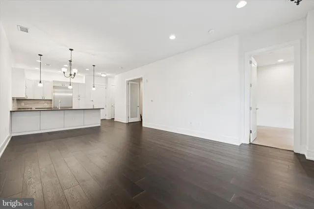 a view of a kitchen with wooden floor and a sink