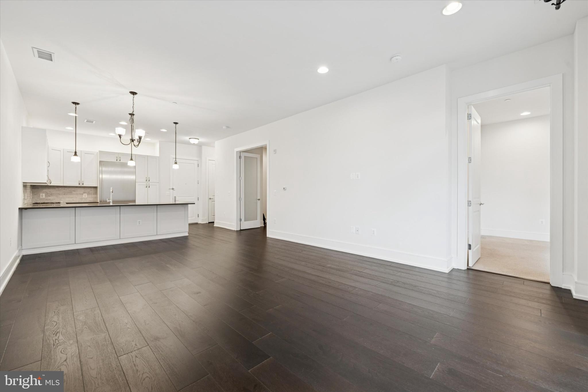 410 South Front Street, Unit 313 Philadelphia, PA 19147 - Photo 5 of 24 a view of a kitchen with wooden floor and a sink