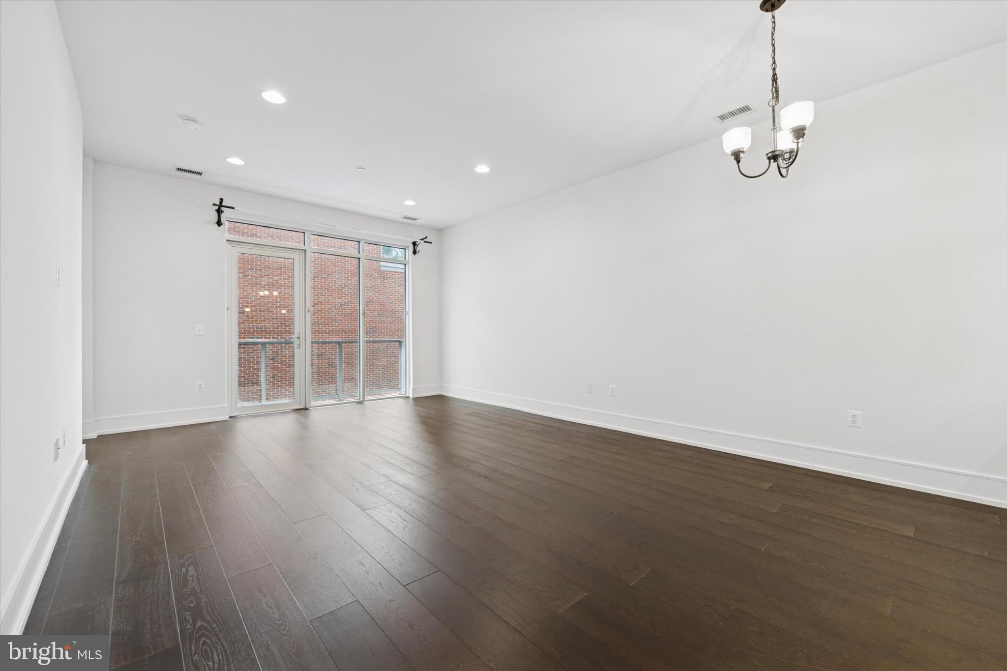 410 South Front Street, Unit 313 Philadelphia, PA 19147 - Photo 6 of 24 a view of empty room with wooden floor and fan