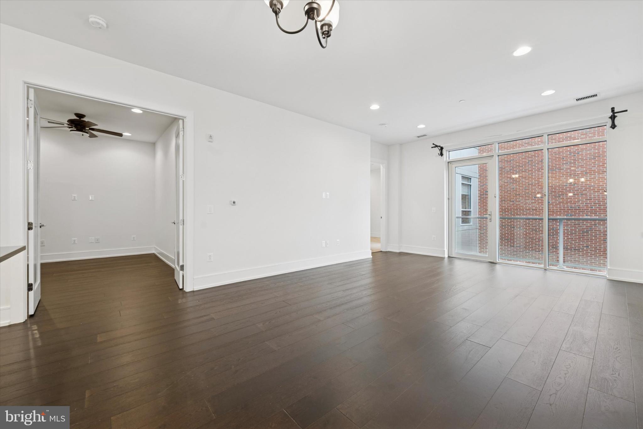 410 South Front Street, Unit 313 Philadelphia, PA 19147 - Photo 7 of 24 an empty room with wooden floor and windows