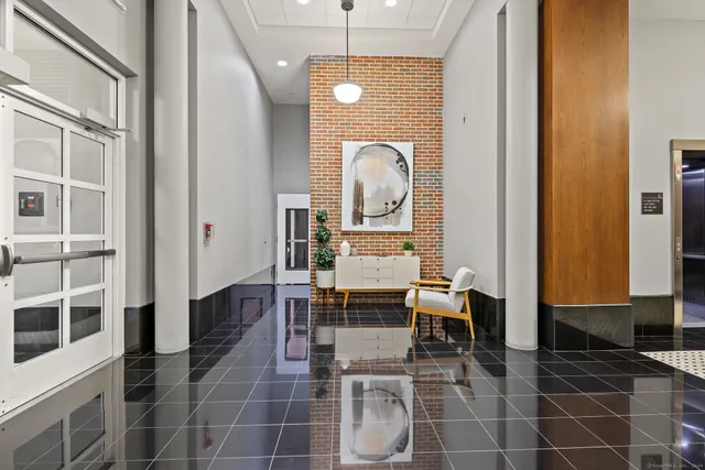 a dining room with furniture and a mirror