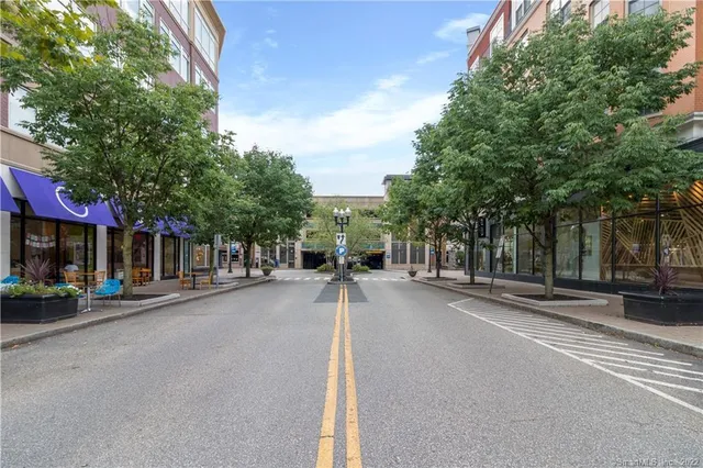 a city street lined with buildings and cars
