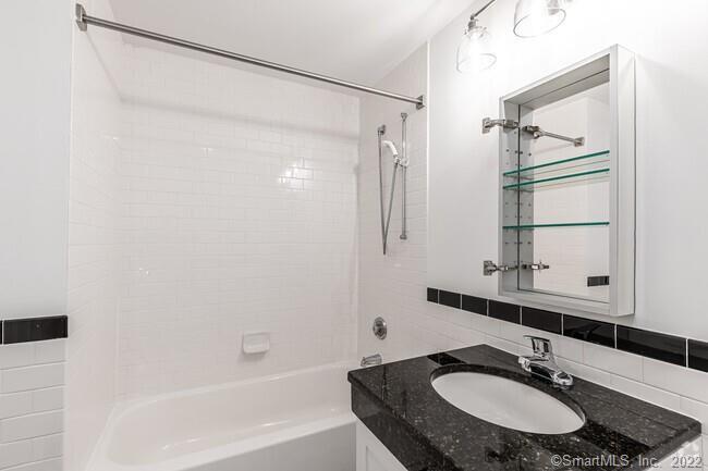 15 Dinah Road, Unit 223 West Hartford, CT 06107 - Photo 9 of 36 a bathroom with a sink and a mirror