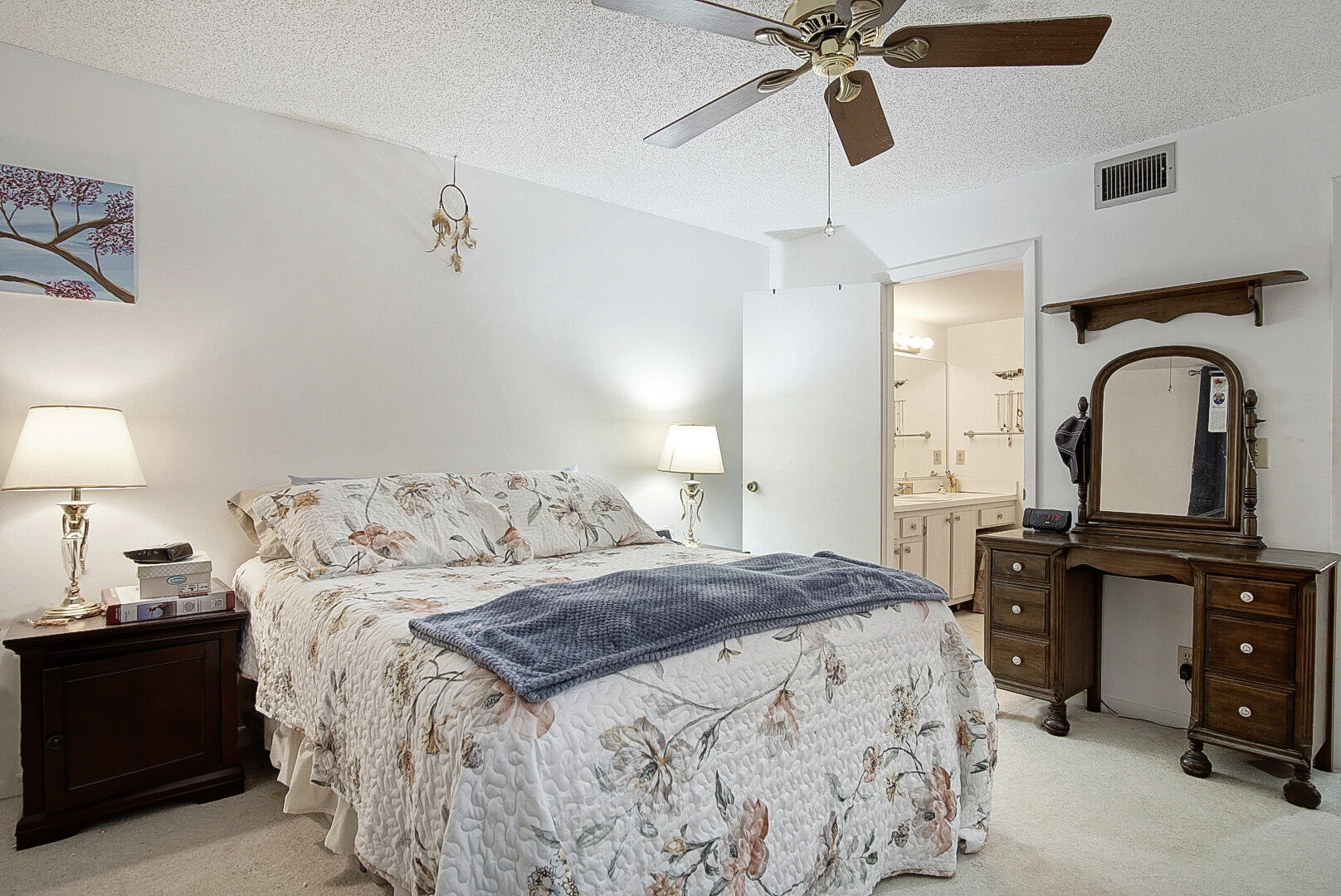 5930 Whispering Pine Way, Unit C2 Greenacres, FL 33463 - Photo 12 of 20 a bedroom with a bed and dresser with mirror