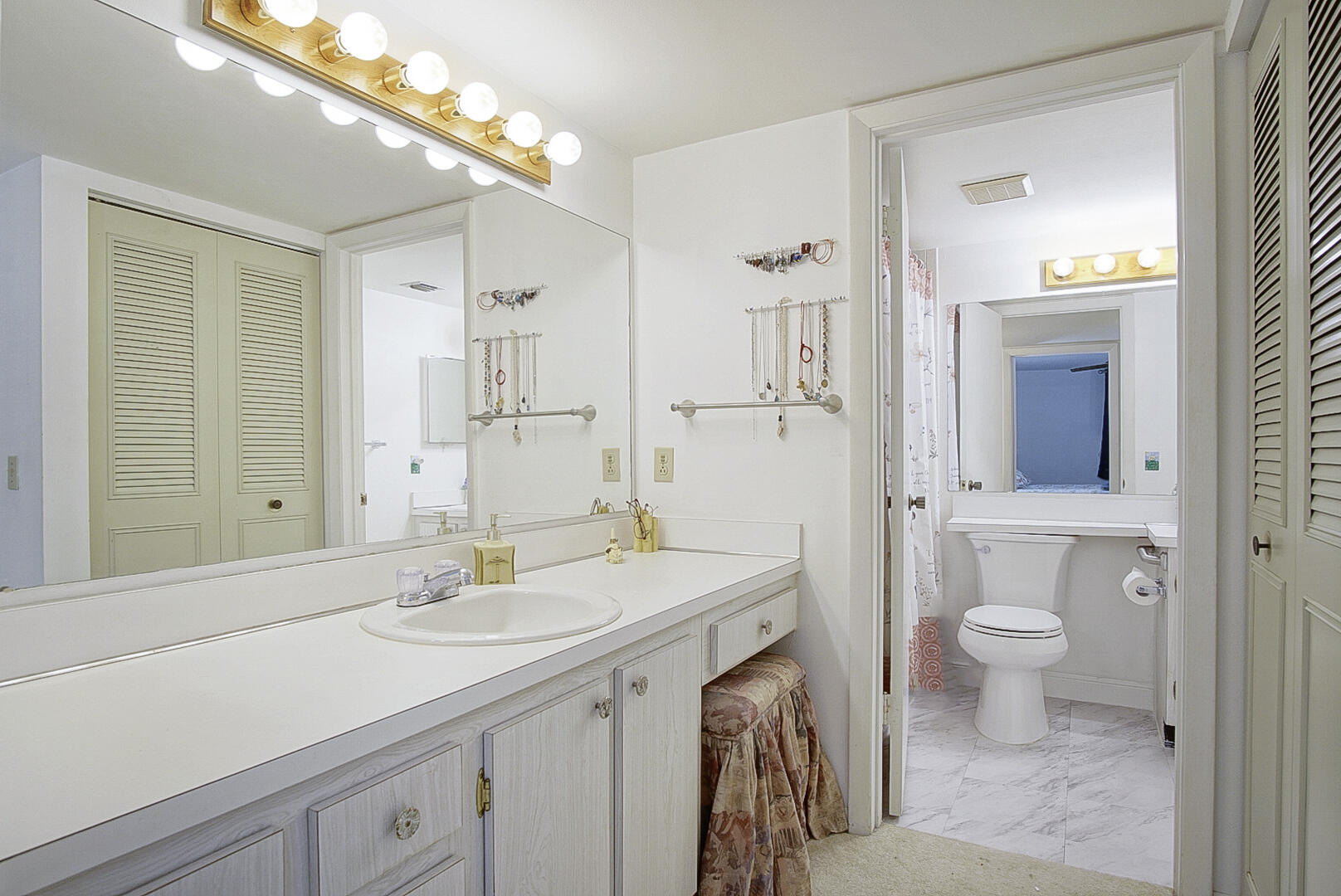 5930 Whispering Pine Way, Unit C2 Greenacres, FL 33463 - Photo 13 of 20 a view of bathroom with a sink mirror and toilet