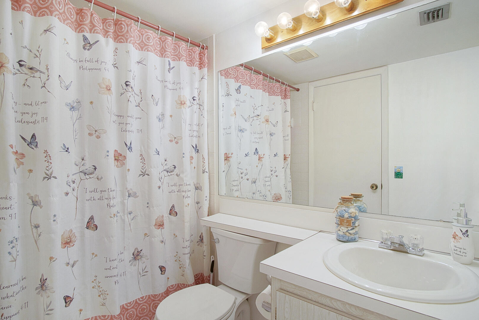 5930 Whispering Pine Way, Unit C2 Greenacres, FL 33463 - Photo 14 of 20 a bathroom with a sink a toilet and shower curtain