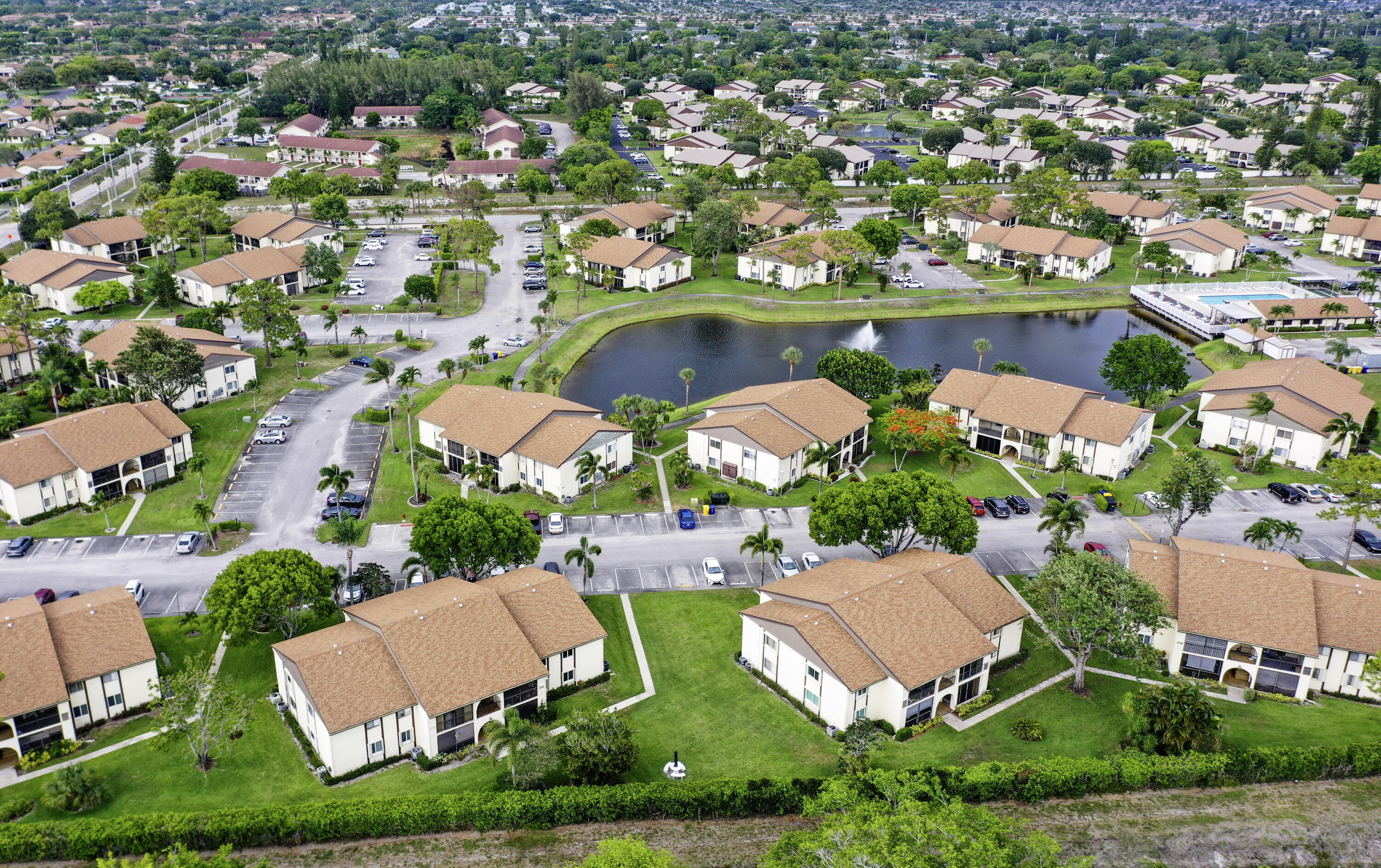5930 Whispering Pine Way, Unit C2 Greenacres, FL 33463 - Photo 17 of 20 an aerial view of residential houses with outdoor space and a lake view
