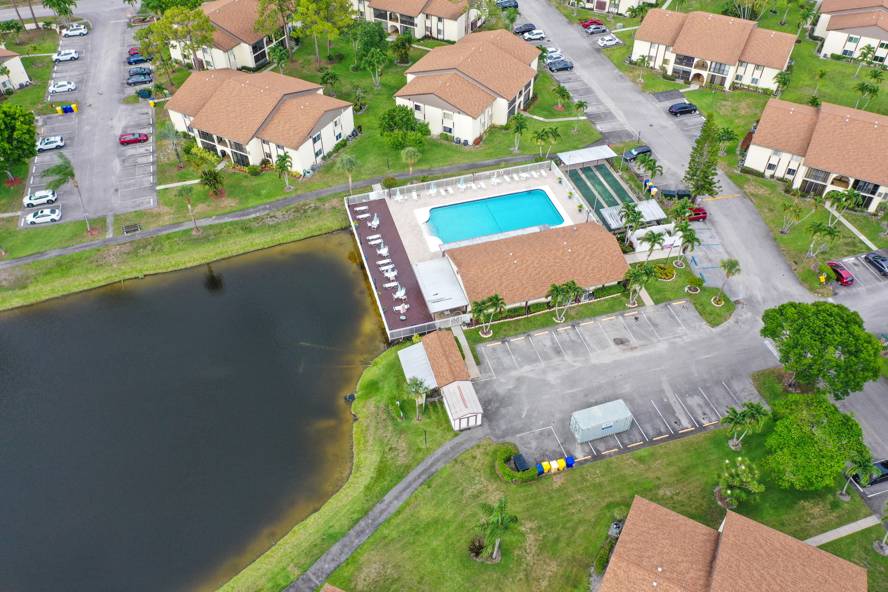 5930 Whispering Pine Way, Unit C2 Greenacres, FL 33463 - Photo 18 of 20 an aerial view of a house with a garden and swimming pool