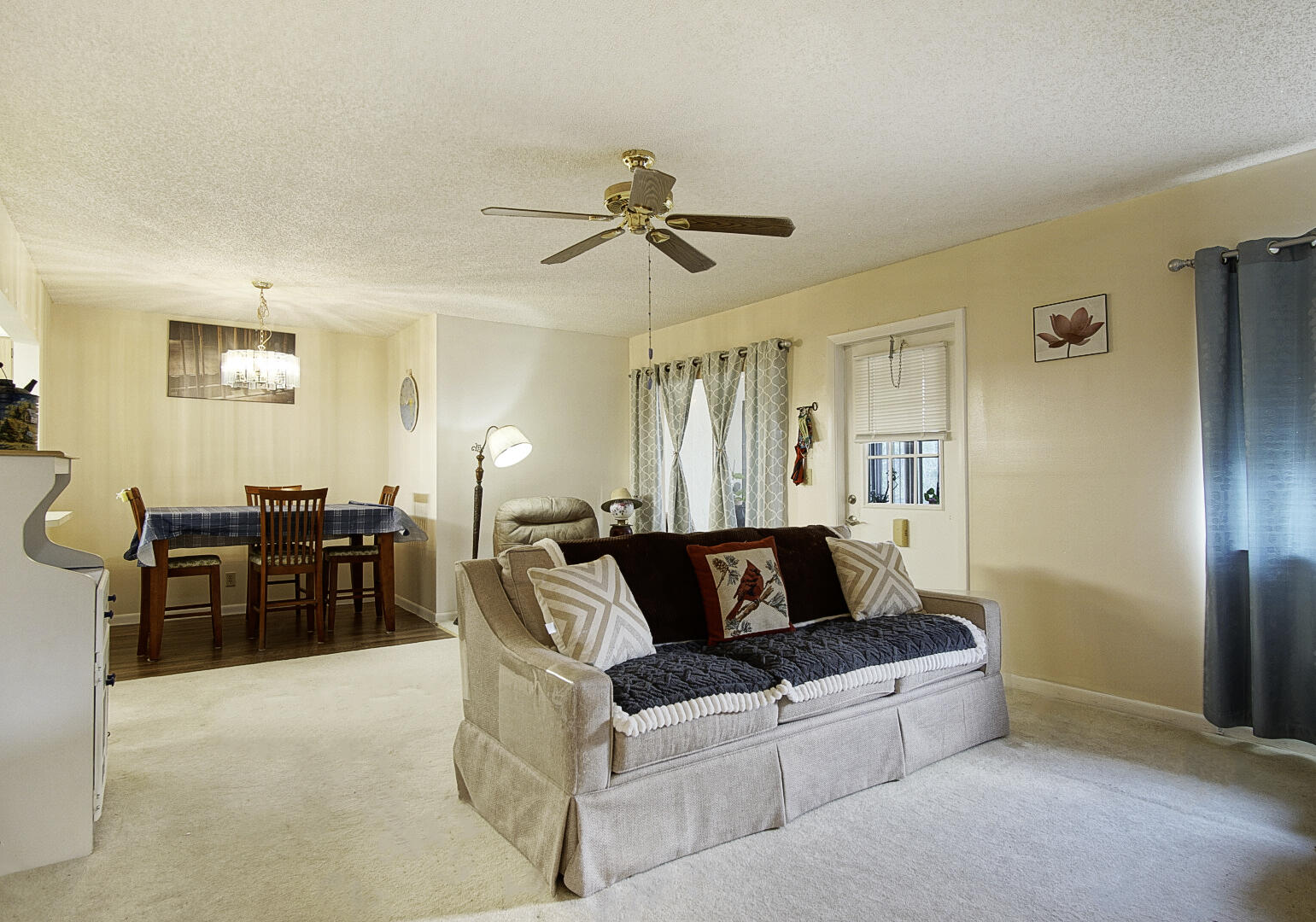 5930 Whispering Pine Way, Unit C2 Greenacres, FL 33463 - Photo 9 of 20 a living room with furniture a chandelier and a dining table