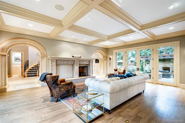 a living room with furniture a rug and a large window