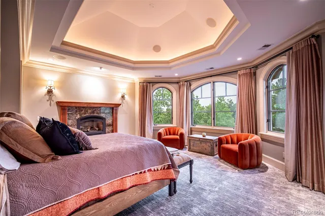 a living room with a bed furniture and a fireplace