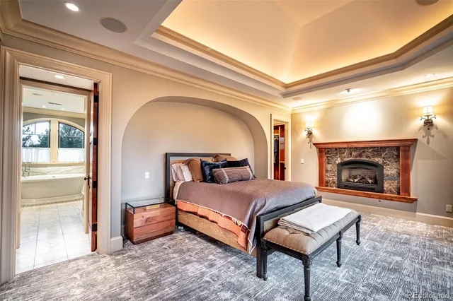 a spacious bathroom with a bathtub shower sink mirror and toilet