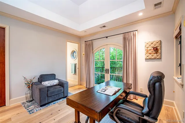 a living room with furniture a ceiling fan and a large window