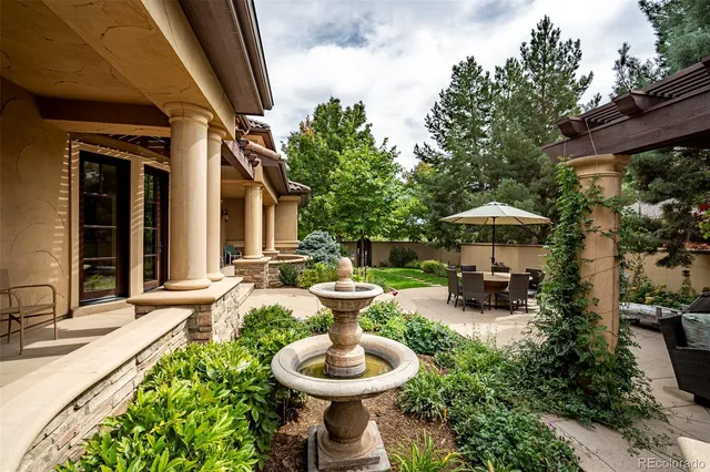 a view of a patio with chairs and plants