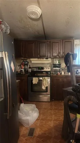 a kitchen with stainless steel appliances granite countertop a stove a refrigerator and a sink