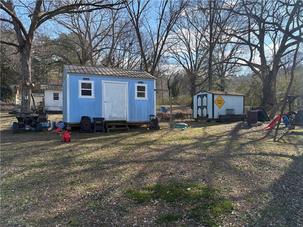 225 Jasper Street Fairmount, GA 30139 - Photo 15 of 15 a view of a house with a yard covered in snow