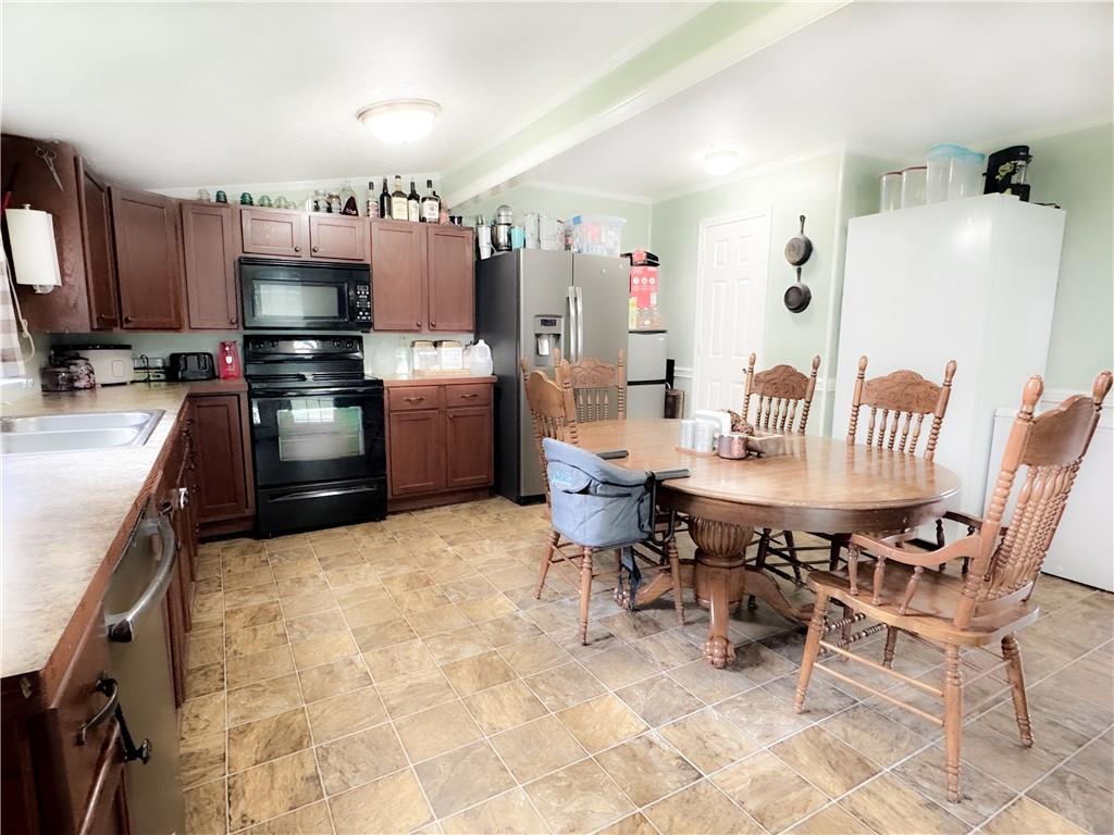 225 Jasper Street Fairmount, GA 30139 - Photo 6 of 15 a kitchen with granite countertop a sink appliances and cabinets