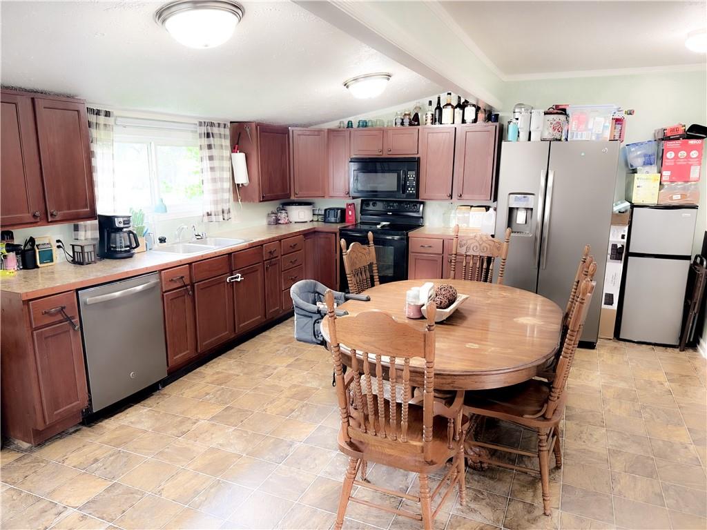 225 Jasper Street Fairmount, GA 30139 - Photo 7 of 15 a kitchen with stainless steel appliances granite countertop a sink a stove a dining table and chairs