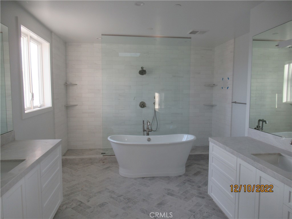 1300 11th Street Manhattan Beach, CA 90266 - Photo 14 of 19 a bathroom with a sink a mirror and a bathtub