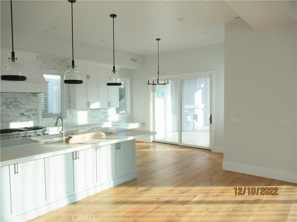 1300 11th Street Manhattan Beach, CA 90266 - Photo 7 of 19 a view of a kitchen with kitchen island sink and wooden floor
