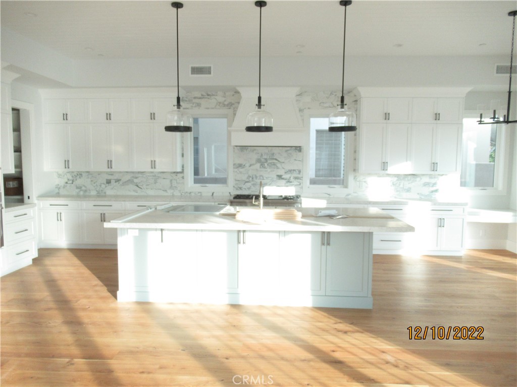 1300 11th Street Manhattan Beach, CA 90266 - Photo 8 of 19 a large kitchen with kitchen island sink stove and white cabinets