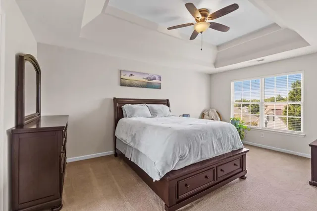 a bed sitting in a room next to a window