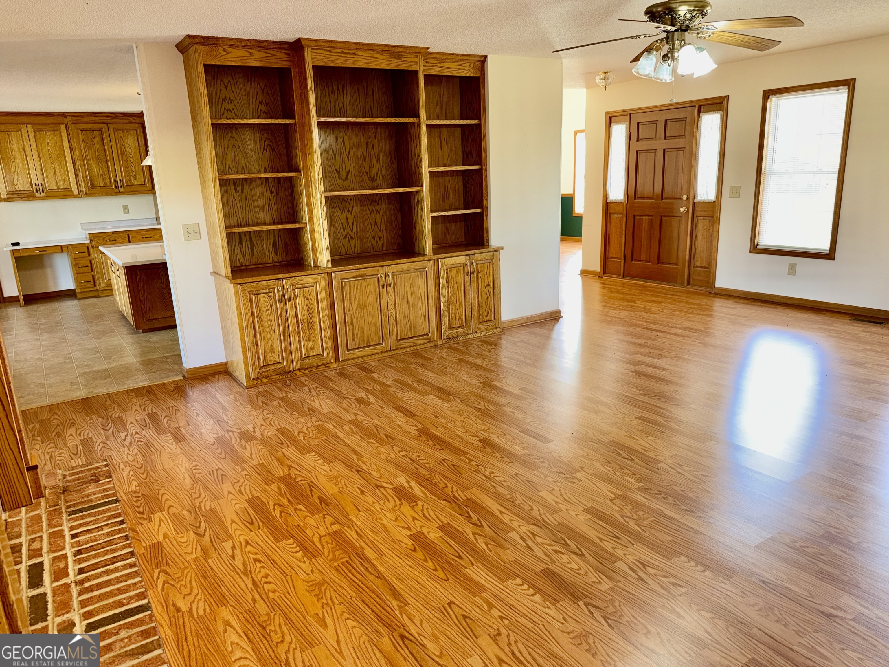 494 Broad Street Bowman, GA 30624 - Photo 17 of 65 a view of an empty room with a window and wooden floor