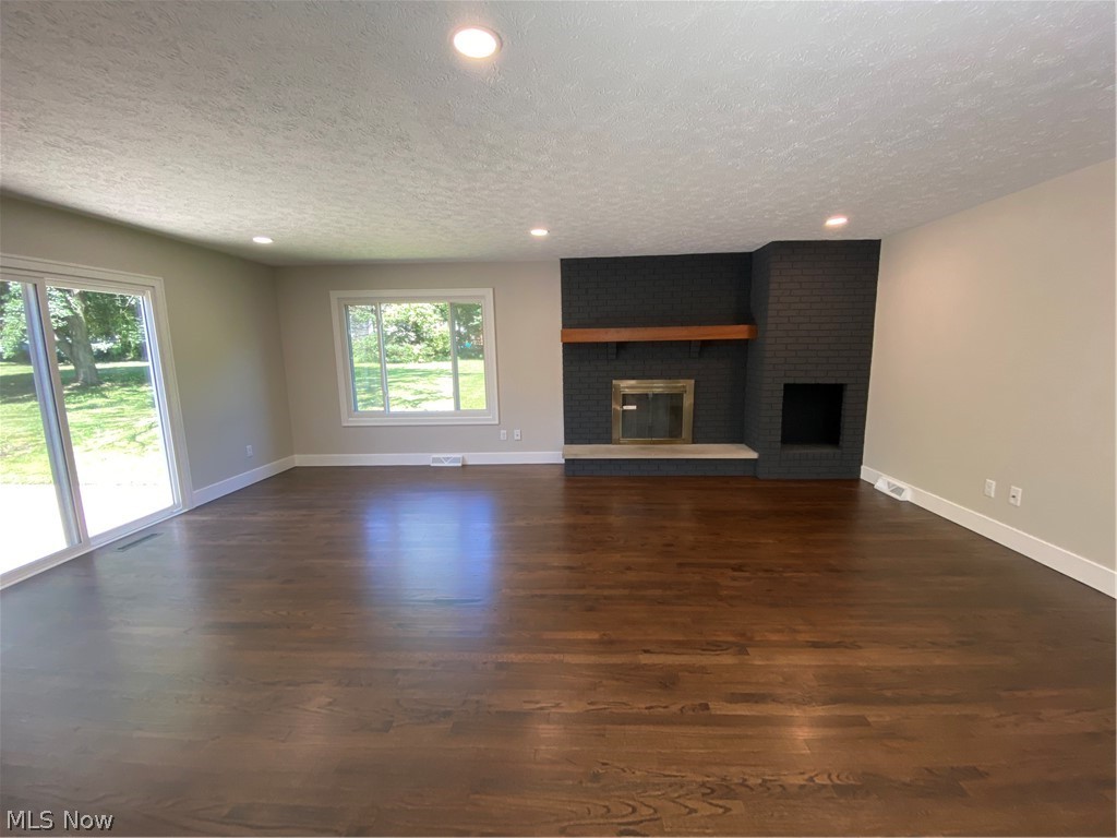 177 Paradise Road Painesville, OH 44077 - Photo 25 of 38 Family room with slider to patio and wood burning fireplace