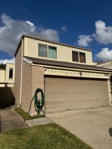 a backyard of a house with barbeque oven